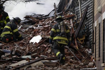 Firefighters go through debris and rubble at the site of a building collapse and fire in Harlem, New York, March 12, 2014. A building collapsed in a largely residential block of Upper Manhattan on Wednesday and the New York City Fire Department was searching for anyone trapped in the debris, officials said. Television images showed heavy smoke and dust rising from the structure at East 114th Street and Park Avenue in East Harlem, which reportedly collapsed at about 9 a.m. (1300 GMT).  REUTERS/Shannon Stapleton  (UNITED STATES - Tags: DISASTER) ORG XMIT: AAL101